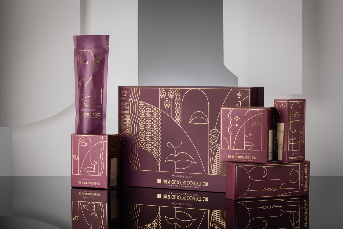 The Glo Skin Beauty Holiday 2026 Icon kits in plum gift boxes